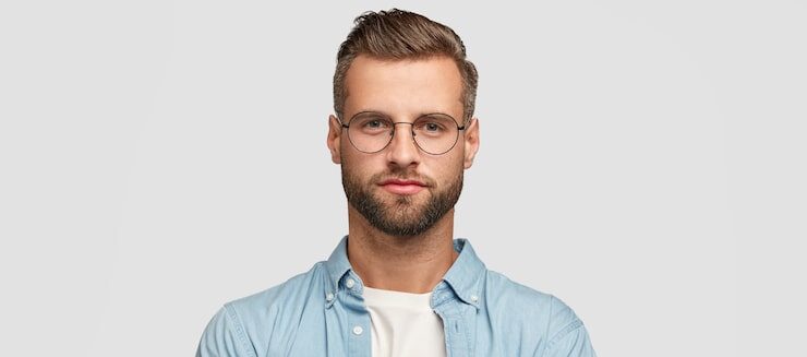 handsome-bearded-guy-posing-against-white-wall_273609-20597